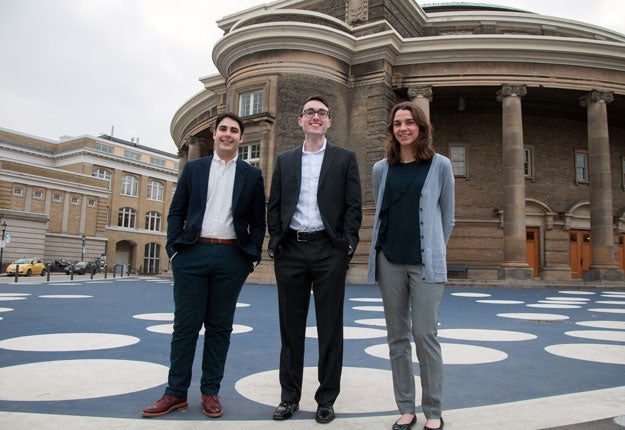 photo of the three Rhodes scholars in front of Convocation Hall