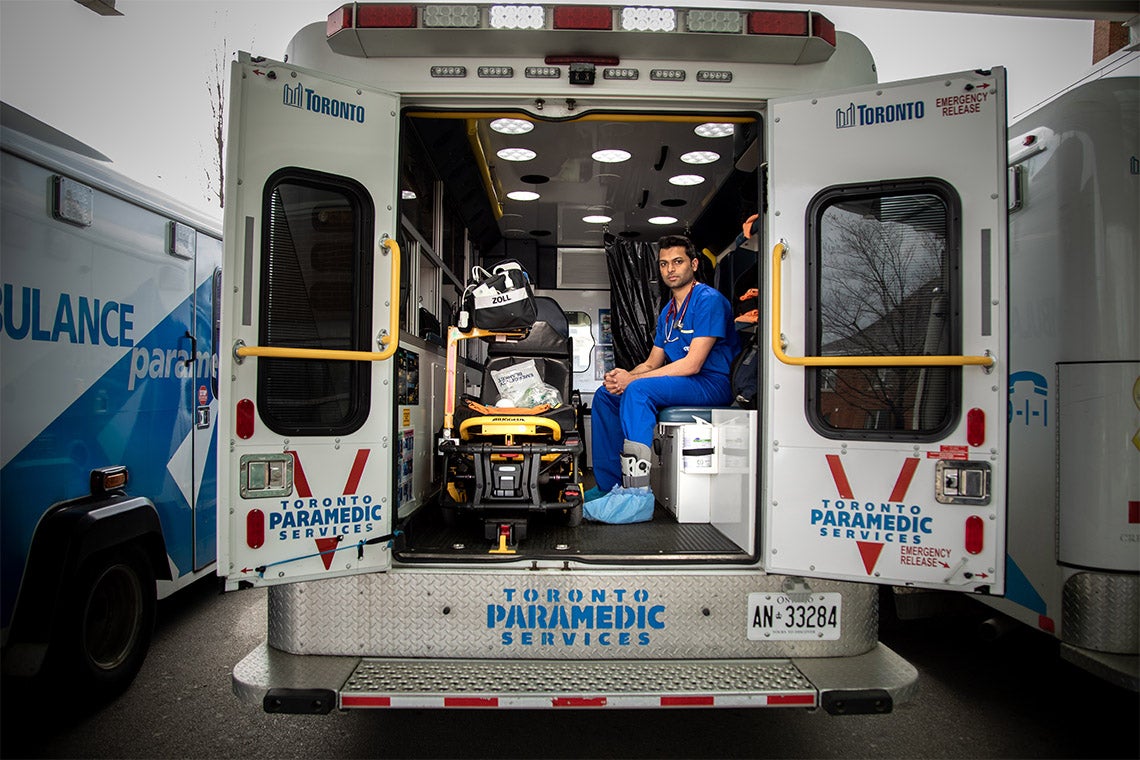 Sameer masood sits in the back of an ambulance