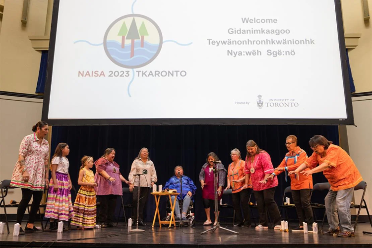 Indigenous people conduct a ceremony to open the 2023 NAISA conference at U of T