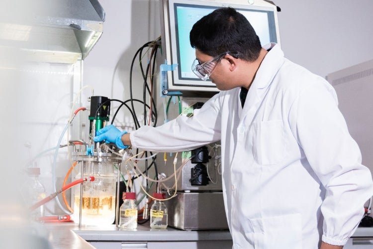 a man examines lab equipment at Ardra's lab