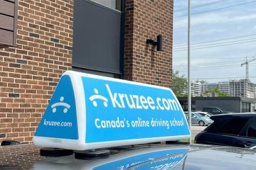 Kruzee sign stuck on top of a car