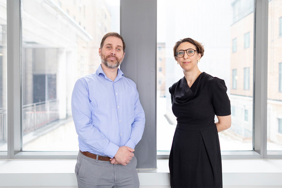 Photo of Robert Kozak and Samira Mubareka standing in front of a window