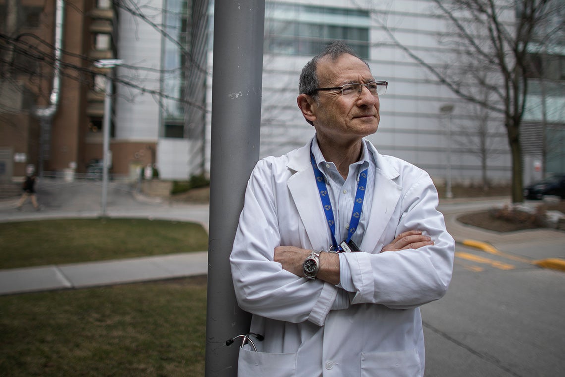 Photo of Joe Fisher, wearing a white lab coat