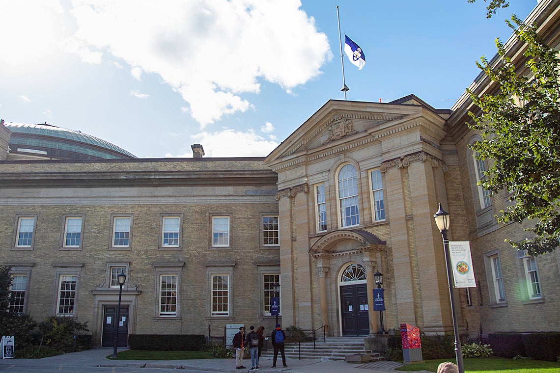 Simcoe Hall with the University flag at half-mast 