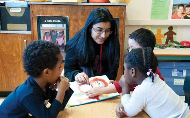 photo of student reading to little kids