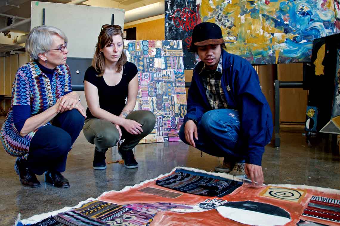 photo of instructors with student and art