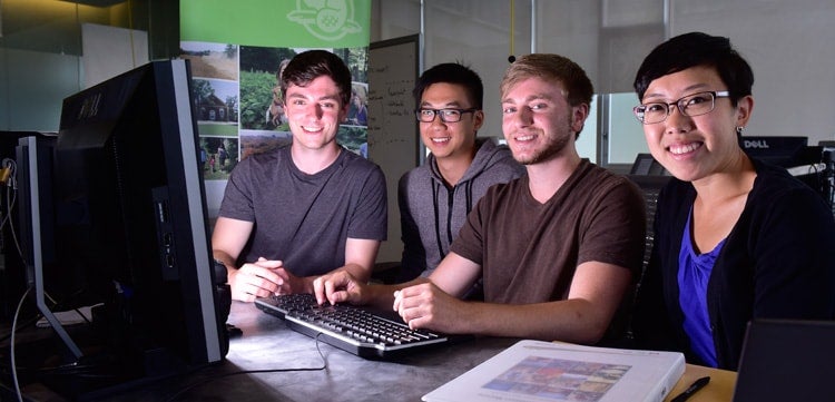 photo of students indoors at computer