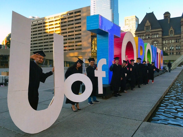 photo of grads with Toronto sign