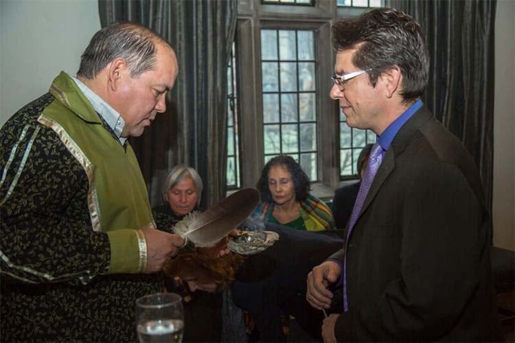 Student, James Bird (left) smudges Jonathan Hamilton-Diabo at TRC entrusment ceremony