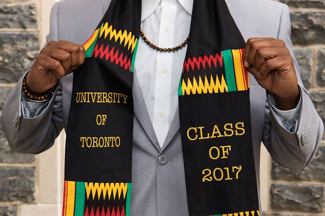 U of T grad shows off a scarf his sister gave him as a grad gift