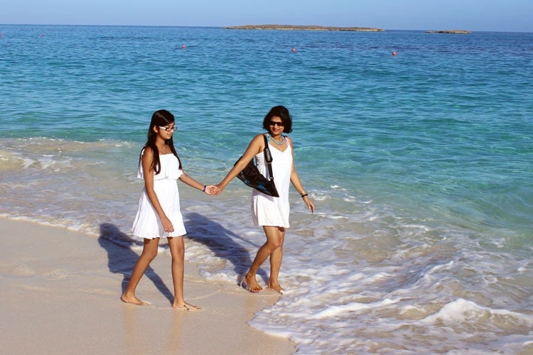 photo of Precilla and Jadyn walking on the beach