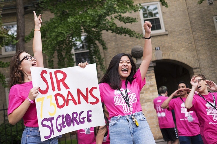 UC frosh leaders welcome students in front of Sir Dan's residence