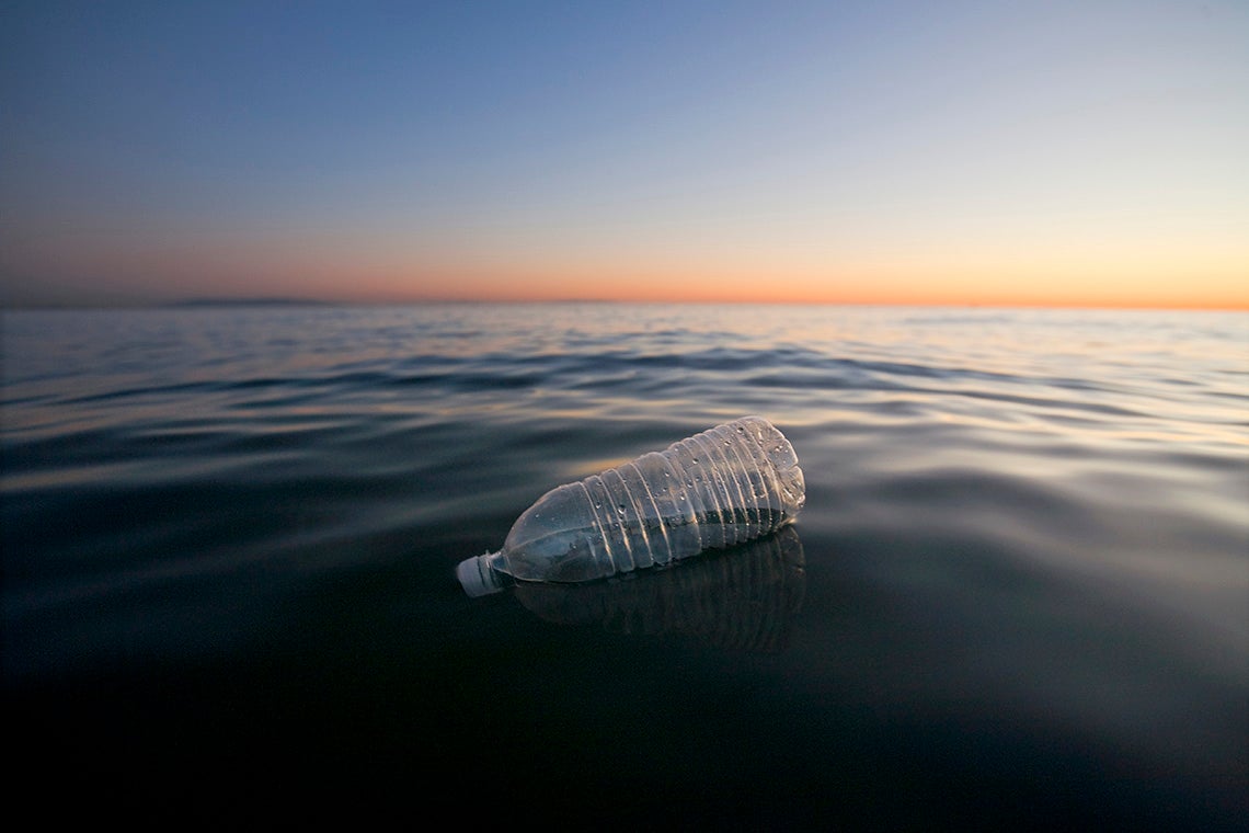 photo of plastic bottle in ocean