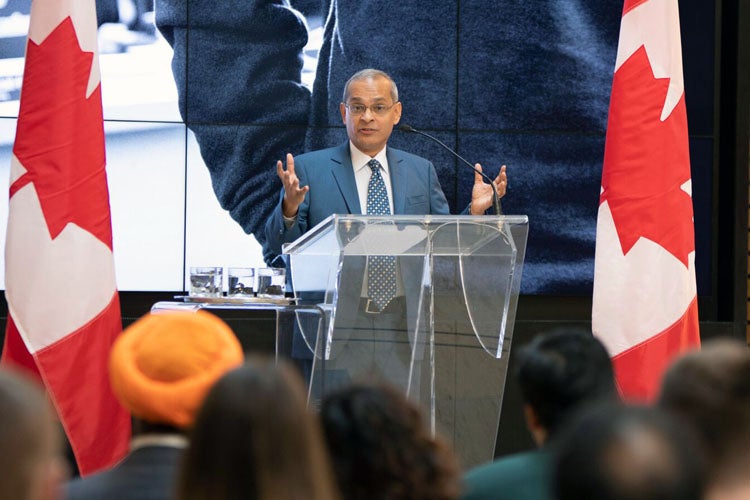 photo of Vivek Goel at lectern