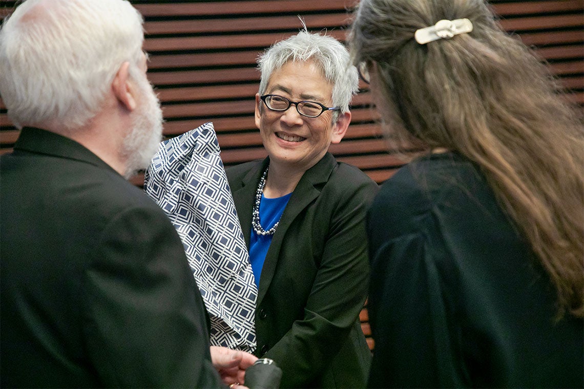 Carol Chin holding a bouquet of flowers following her installation ceremony