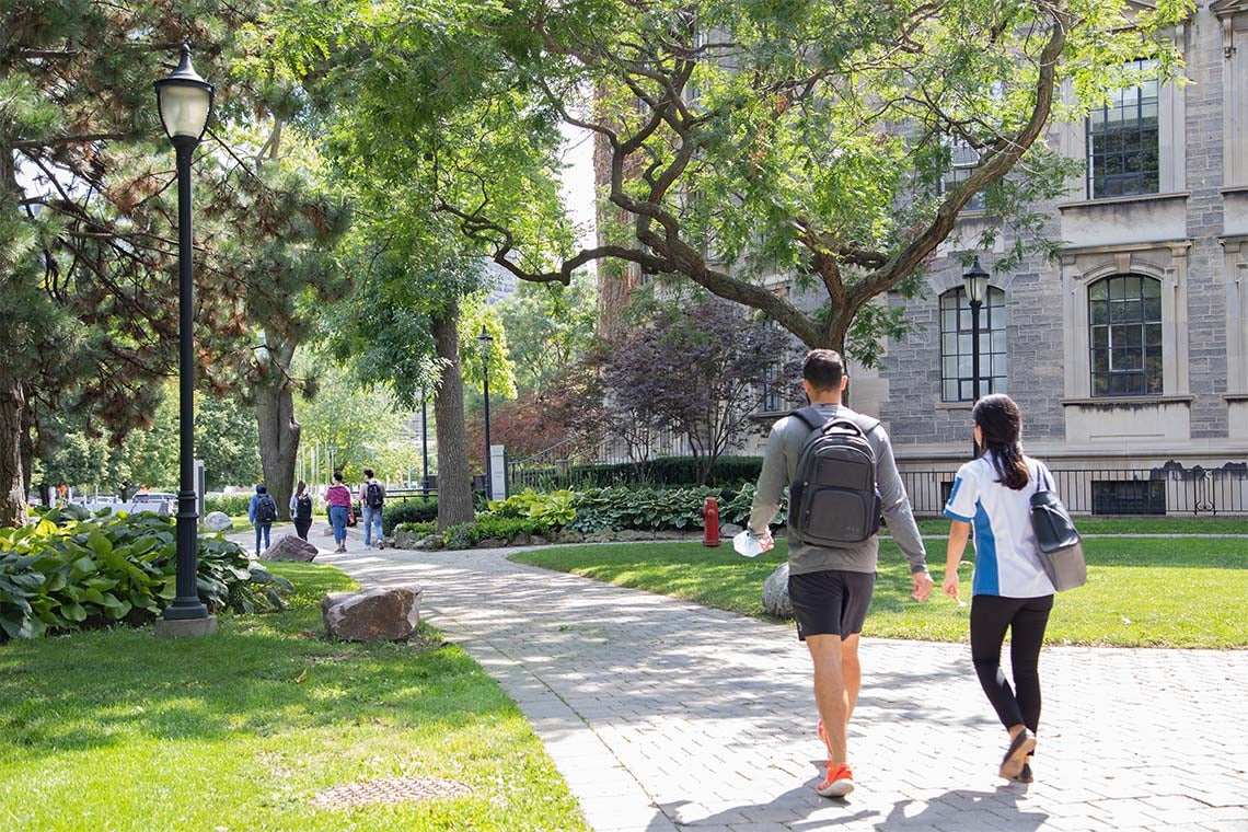 students walking past the David Naylor Building at St. George Campus, University of Toronto