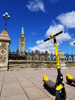 a roll scooter is parked outside parliament hill in ottawa