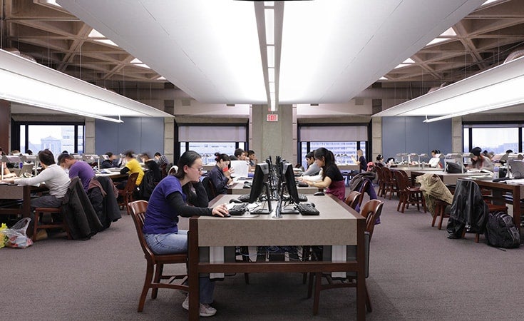 Students study around a table at Robarts Library.