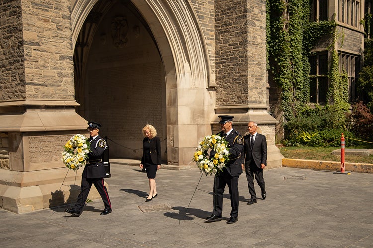 Meric Gertler and Cheryl Regehr place wreathes at the bottom of Soldier's Tower