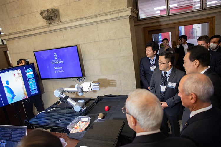 Xinyu Liu runs a robotic hand demonstration for President Yoon Suk-yeol and President Meric Gertler