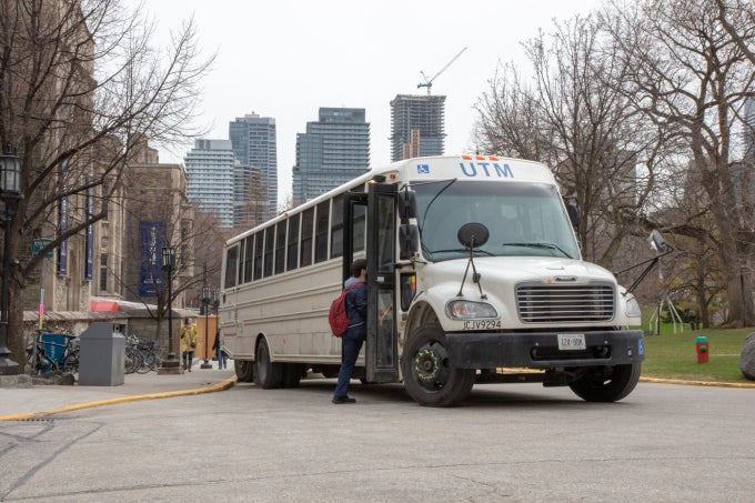 A person walking into a UTM shuttle.