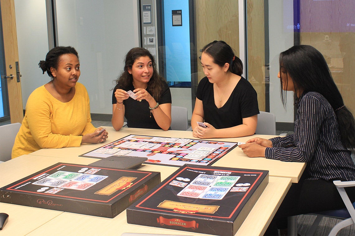 Students playing BioRacer board games