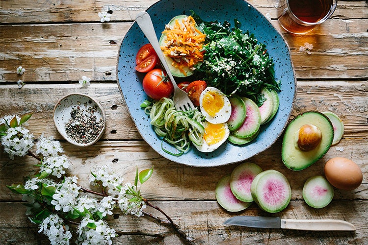 healthy looking salad with avocado, tomatos and other vegetables