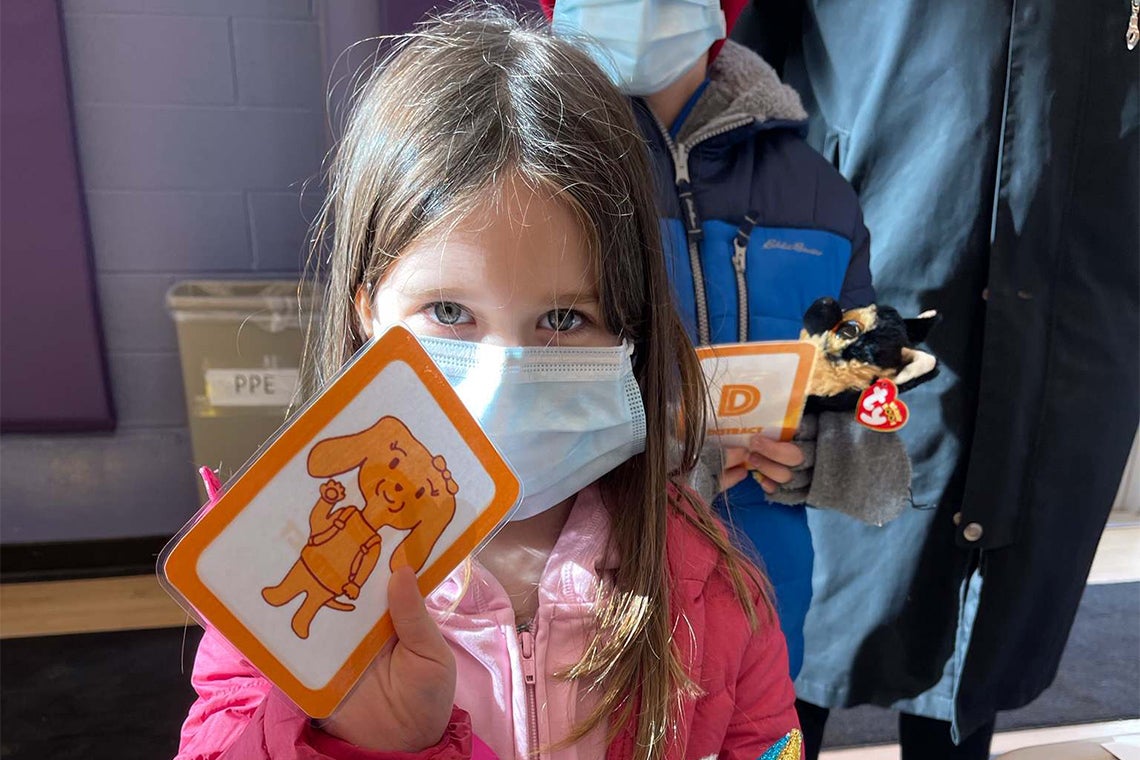 A girl playing the CARD vaccination game