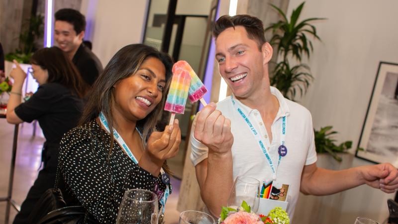 spring soiree participants cheers with rainbow coloured popsicles
