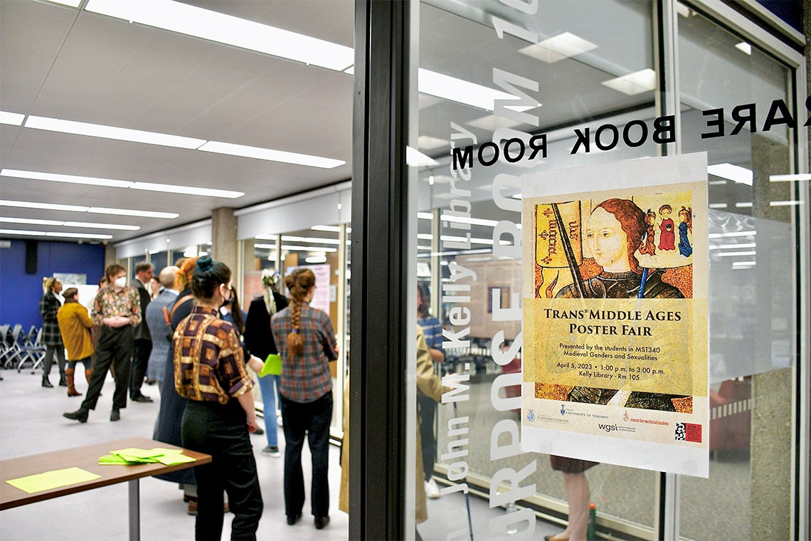 a poster for the Trans middle ages poster fair is seen on the door of the John M. Kelly library multipurpose room