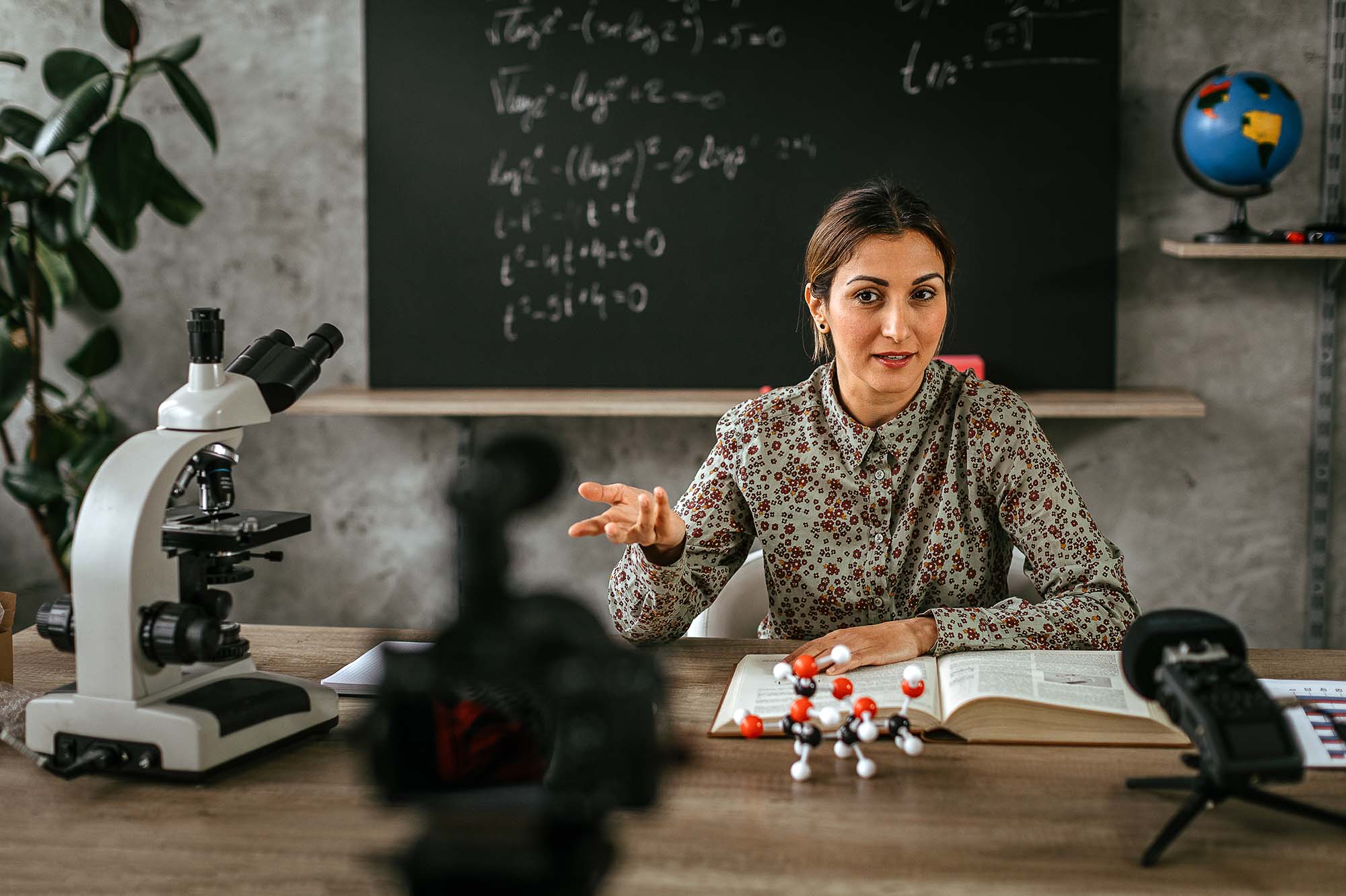 instructor seated at table. being filmed while speaking