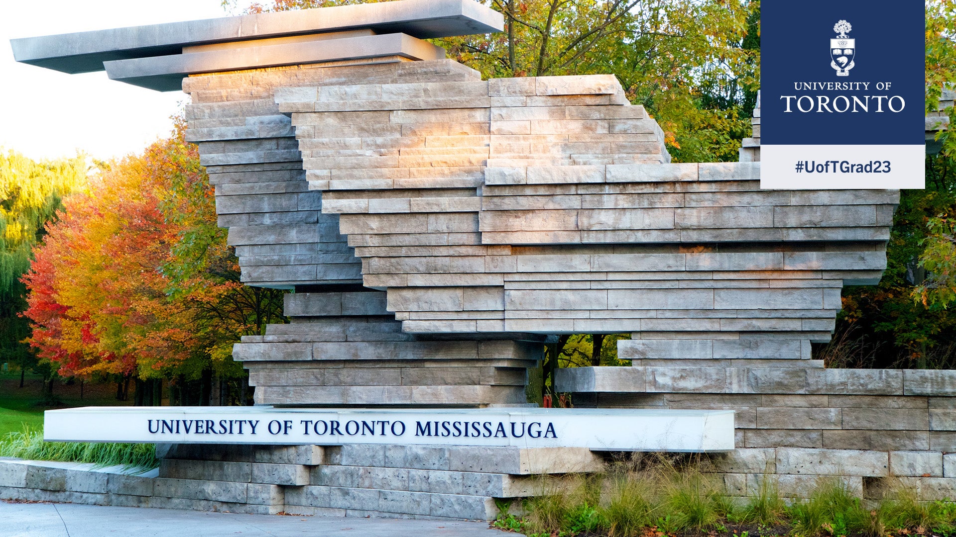 U of T Mississauga sign and rock structure, surrounded by fall foliage