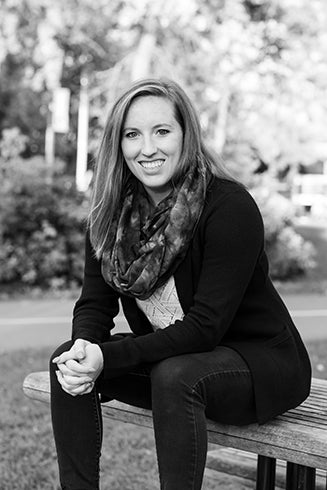 Photo of Maddy Orr, sitting on bench.