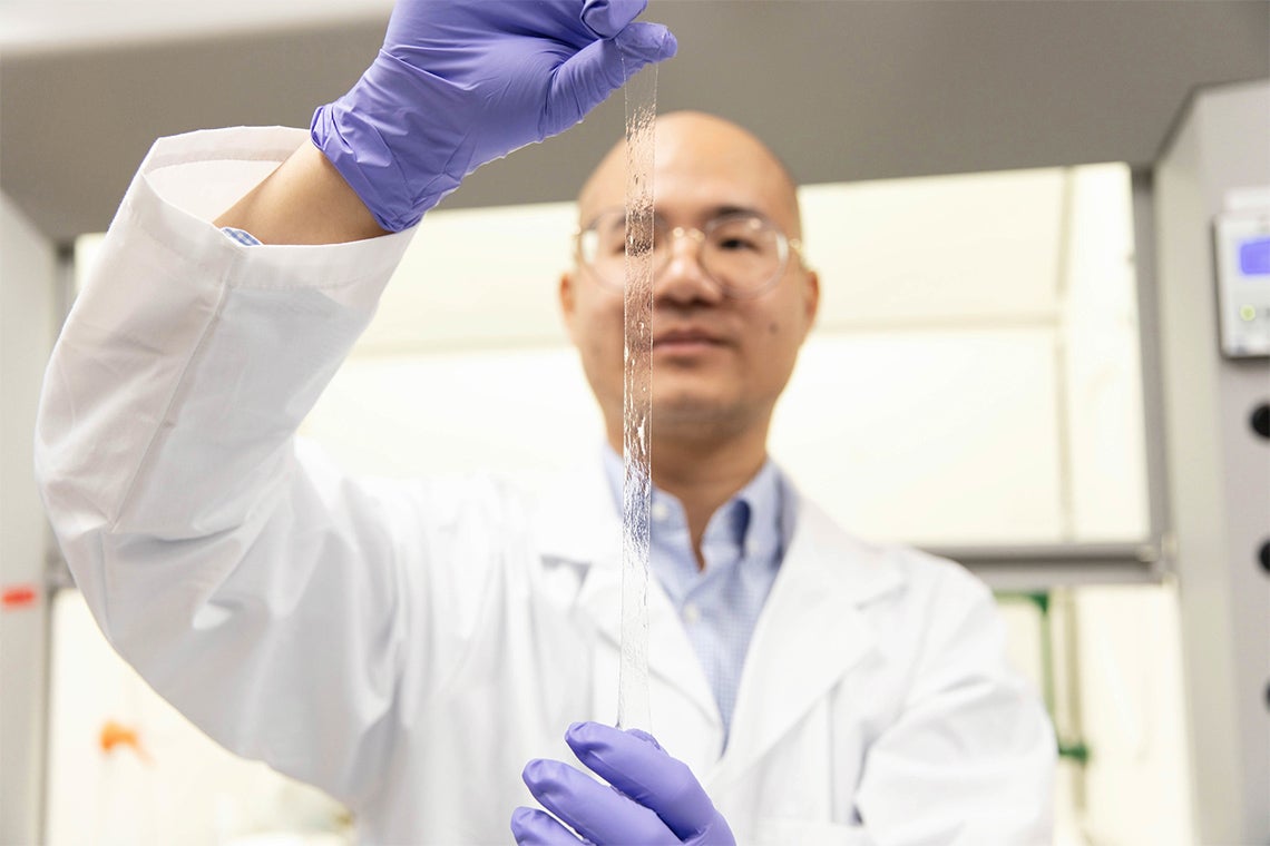 Photo of Binbin Ying demonstrating the AISkin technology in the lab