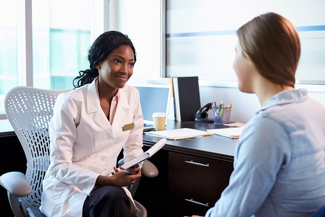 Photo of female doctor talking to patient