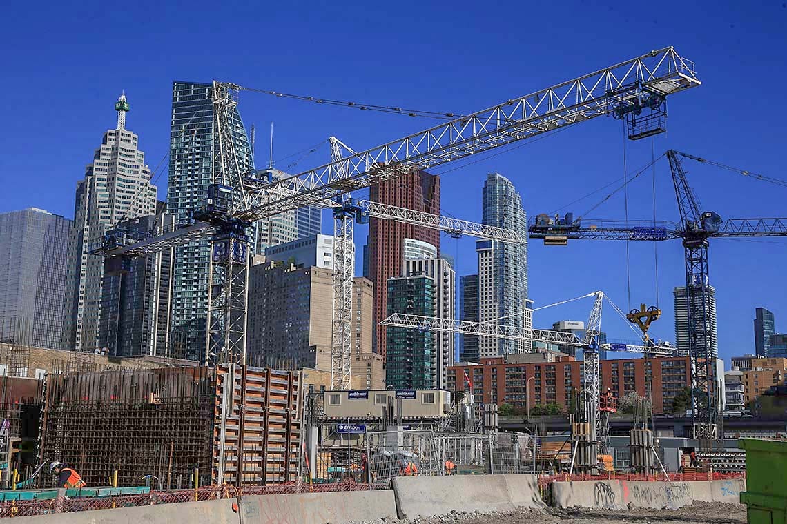 Construction cranes dot the downtown Toronto skyline