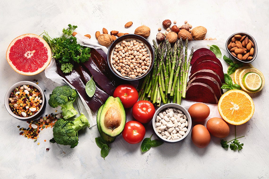 collection of foods high in folic acid including grapefruit, liver, avocado, asparagus, broccoli and nuts
