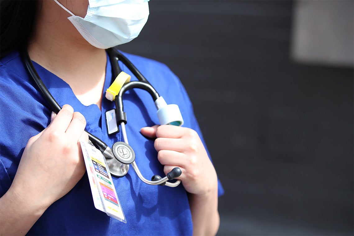 Nurse wearing a mask and holding stethoscope