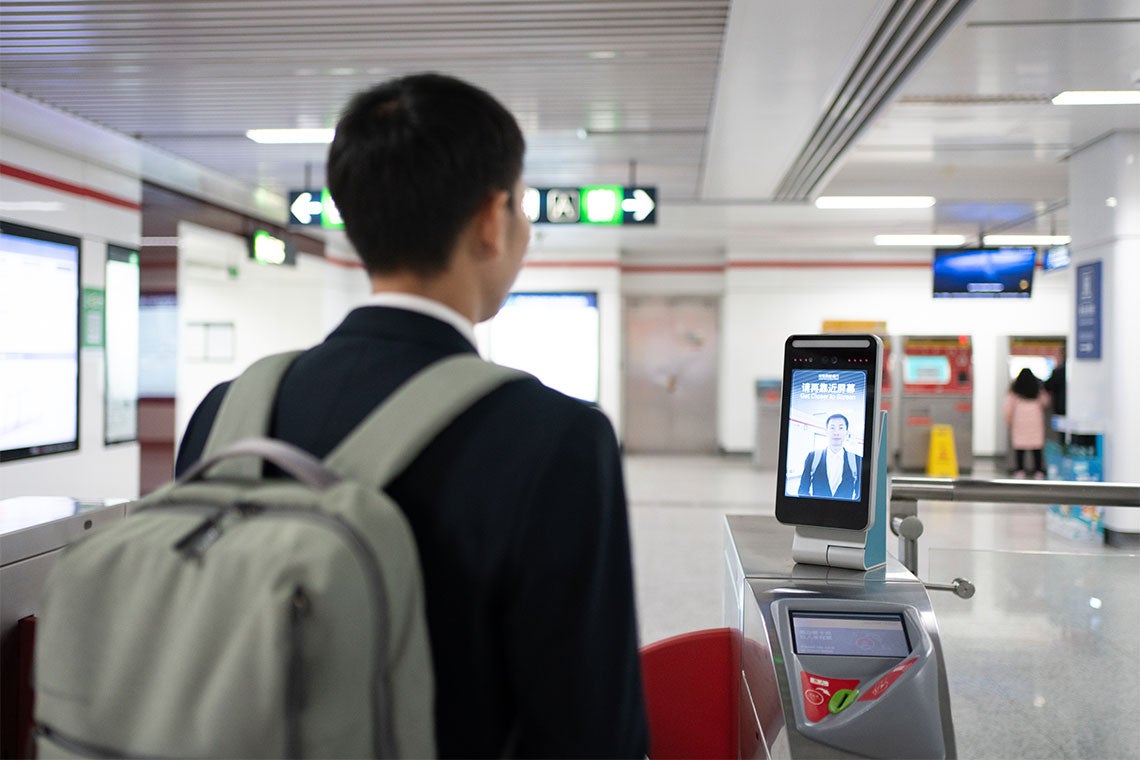a man pays for his subway fare using face recognition technology