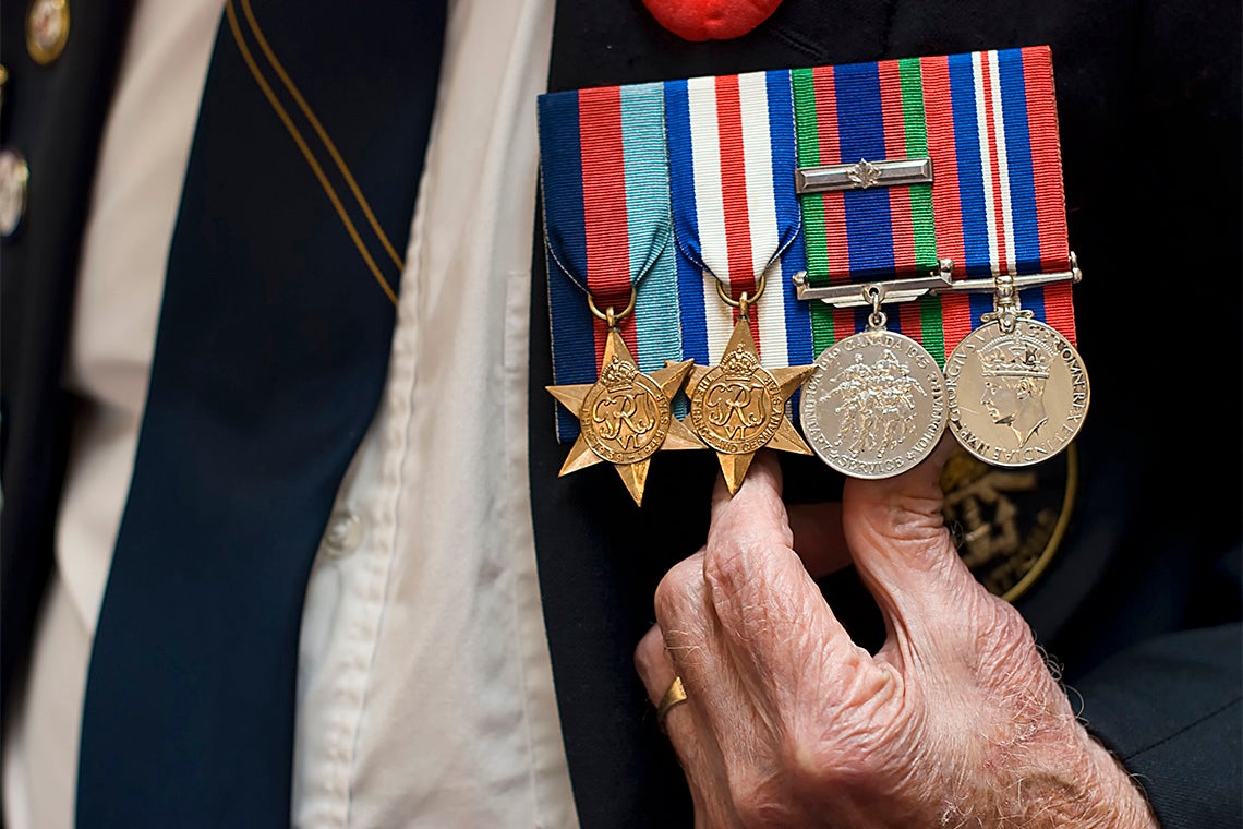 senior citizen wearing naval war medals 