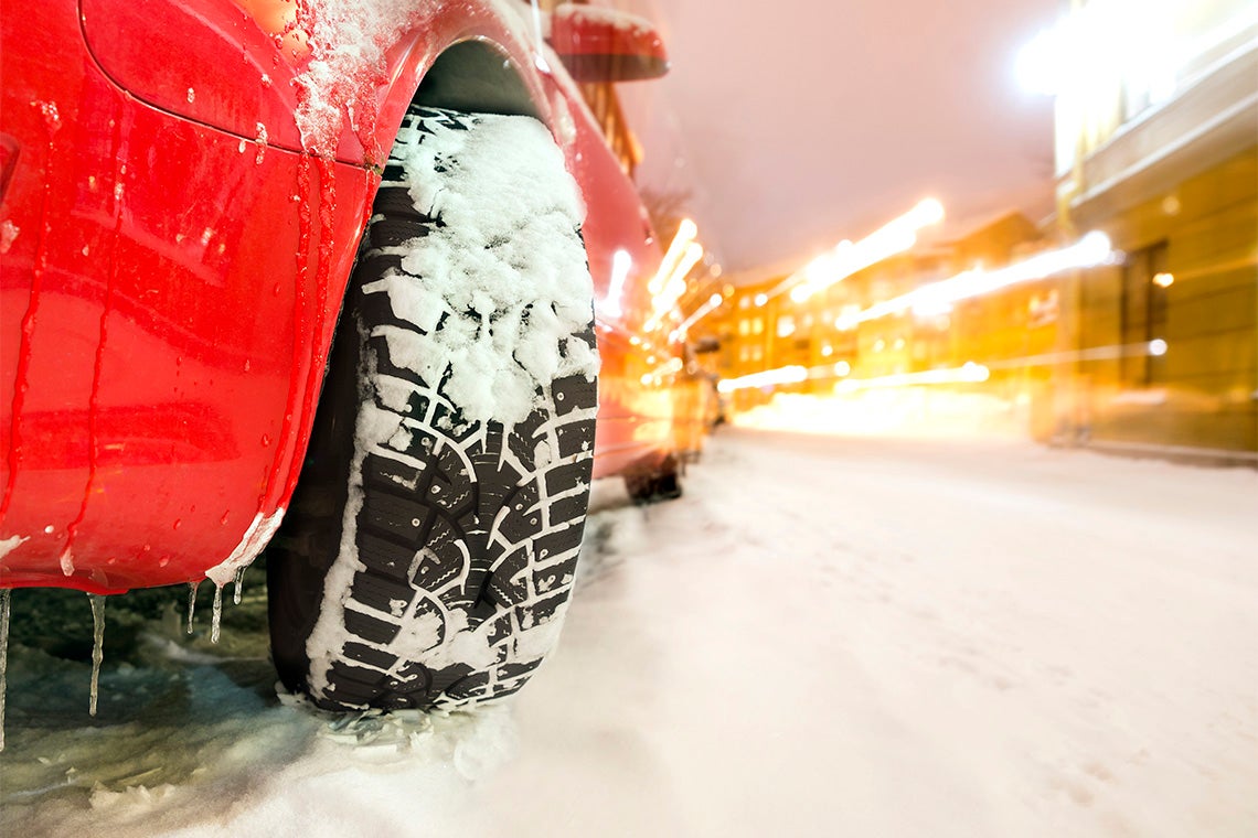 close up of a car tire on a snowy road
