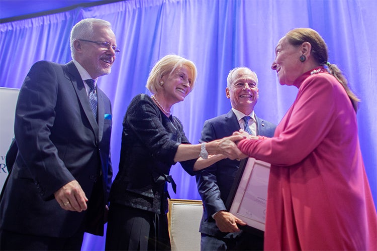 Justice Abella (right) is presented with the Rose Wolfe Distinguished Alumni Award for 2019 by (from left) Scott MacKendrick, past president of the U of T Alumni Association, Chancellor Rose Patten and President Meric Gertler 