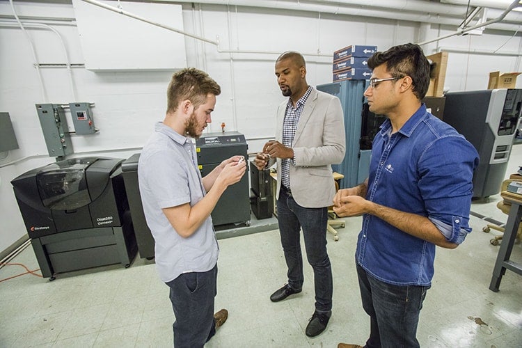 Photo of Kai James and colleagues in lab