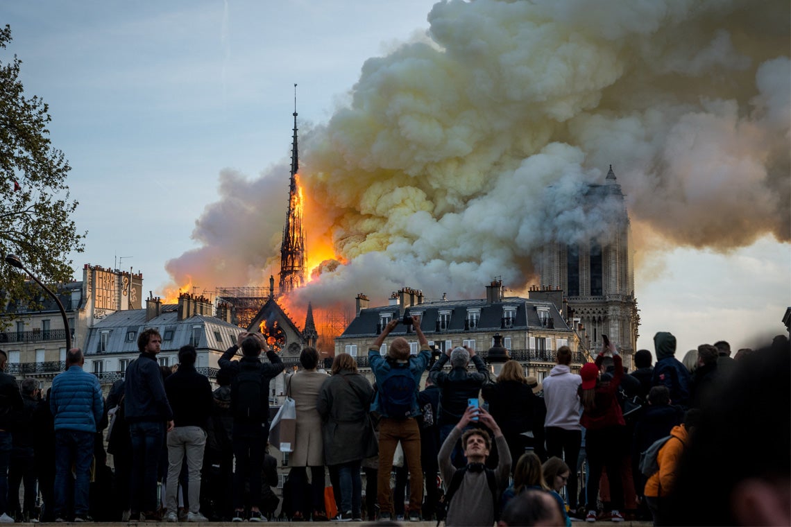 photo of the Notre Dame Cathedral in Paris as the roof burns