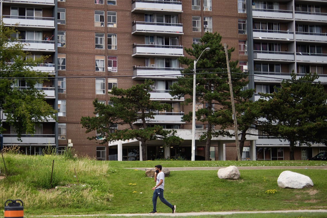 A man walks past a suburban apartment building in Toronto