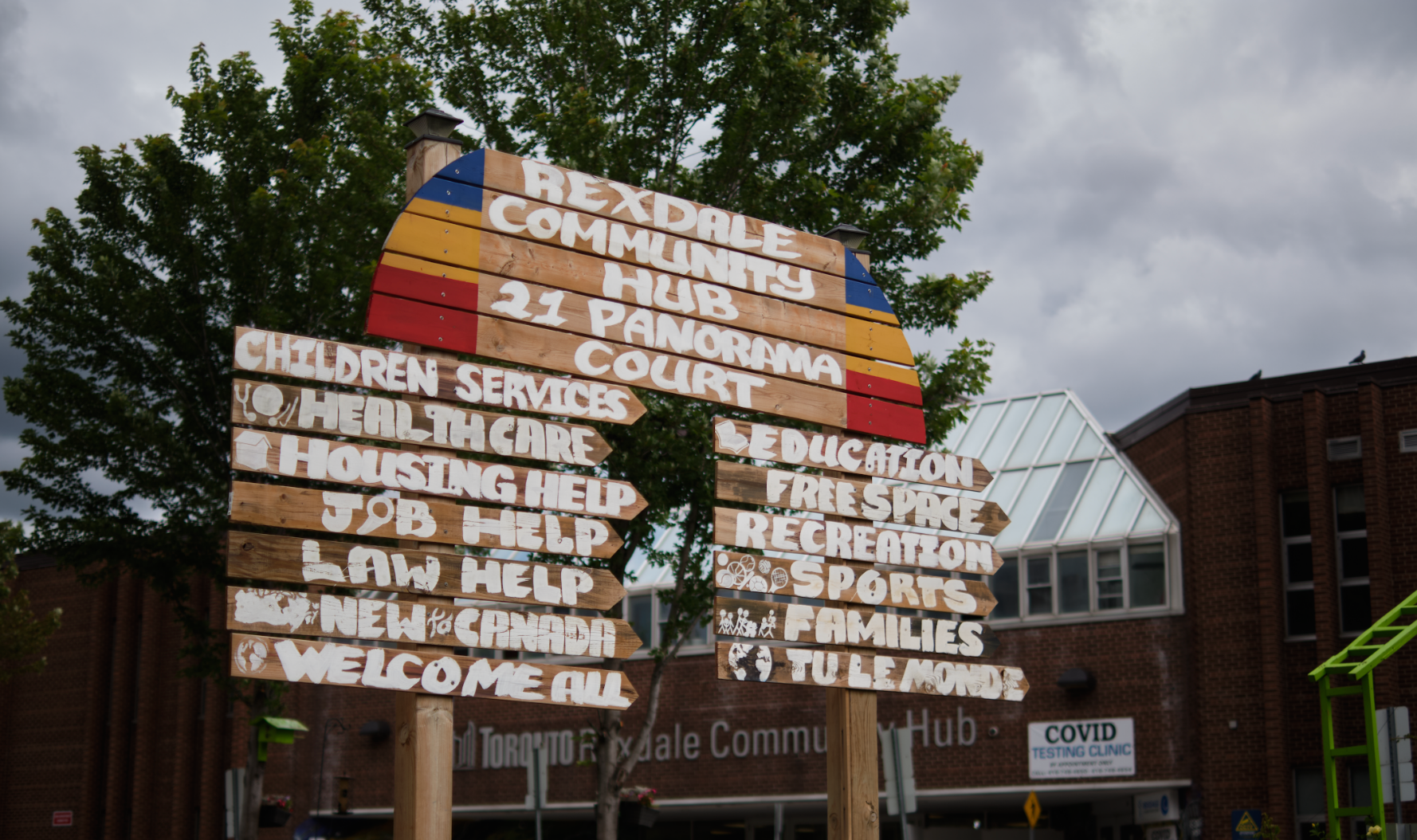 A sign reads "rexdale community hub 11 panorama court" and lists services available such as "Children services" and "housing help"