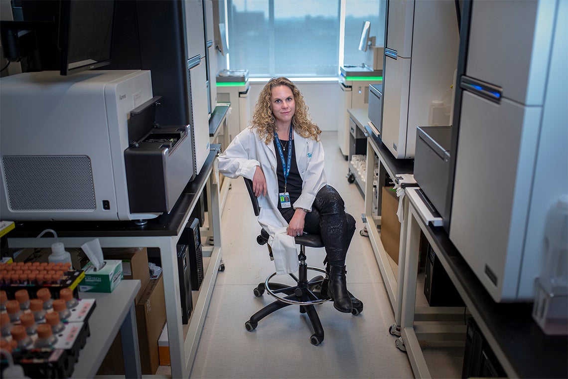 Lisa Strug sits on a chair in a hallway