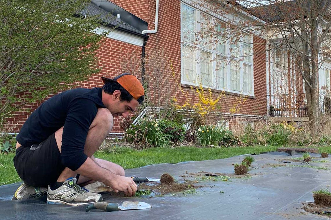 Lucas Albano planting outside of Alumni House at UTM