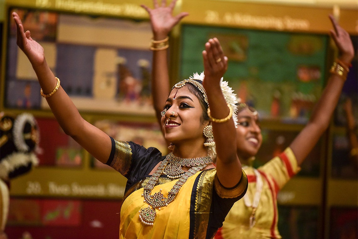 two female dancers in traditional dress perform during UTSC's Tamil Heritage Week