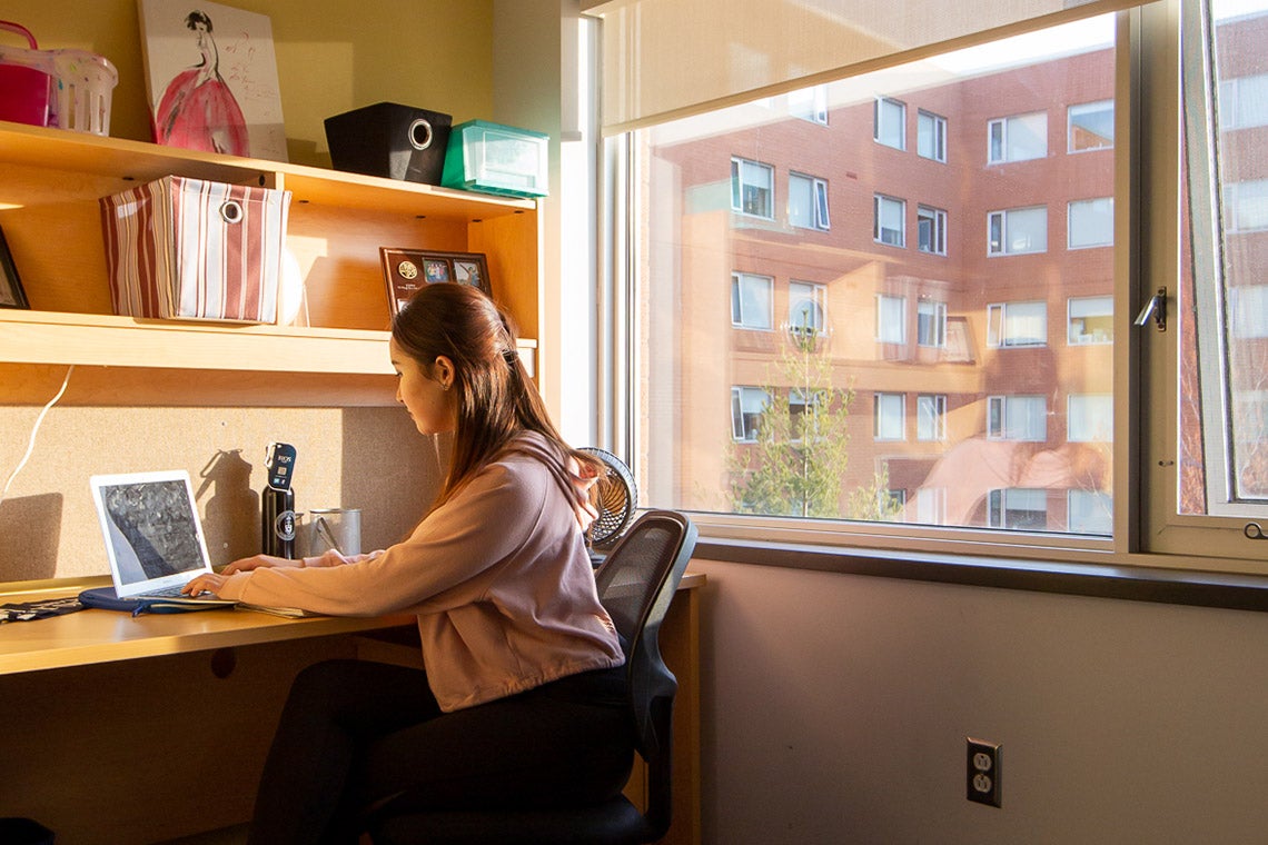 a girl studying at a desk in a residence at UTM
